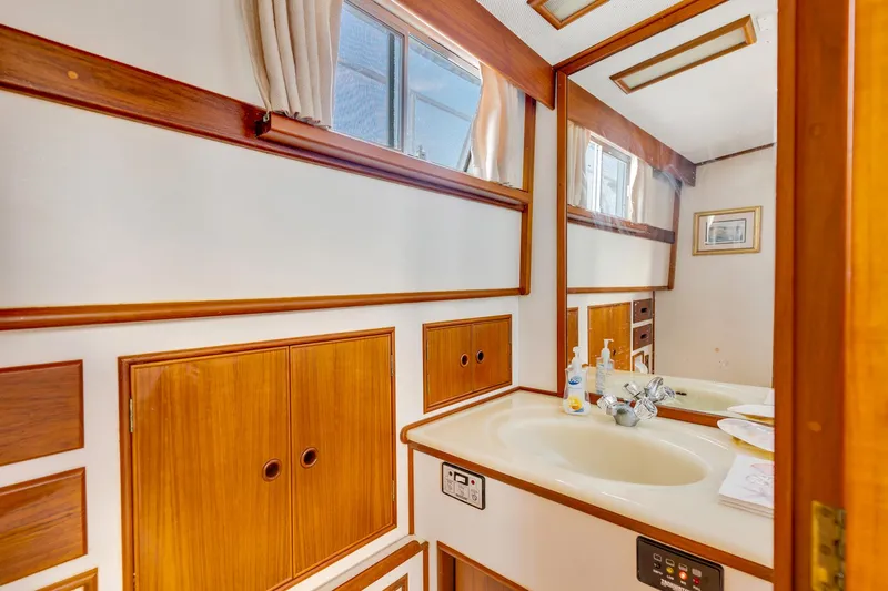 Lu-sea-lu Yacht Photos Pics Bathroom interior of 1994 Grand Banks 42 Classic yacht with wooden cabinetry and sink.