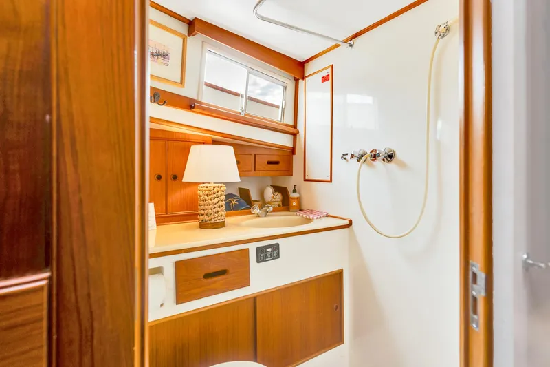 Lu-sea-lu Yacht Photos Pics 1994 Grand Banks 42 Classic yacht bathroom with wood accents and shower.