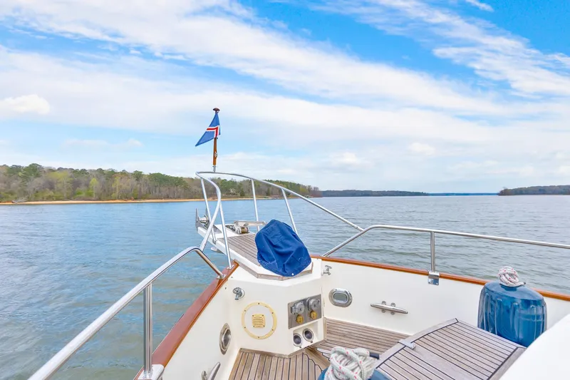 Lu-sea-lu Yacht Photos Pics Grand Banks 42 Classic yacht cruising on a serene lake, 1994 model.