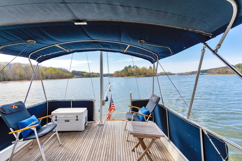 Lu-sea-lu Yacht Photos Pics 1994 Grand Banks 42 Classic yacht deck with chairs, table, and scenic water view.