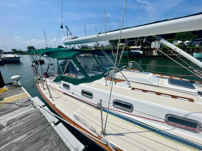  Yacht Photos Pics Tartan 4100 sailboat, 2001 model, docked in a marina under a clear blue sky.
