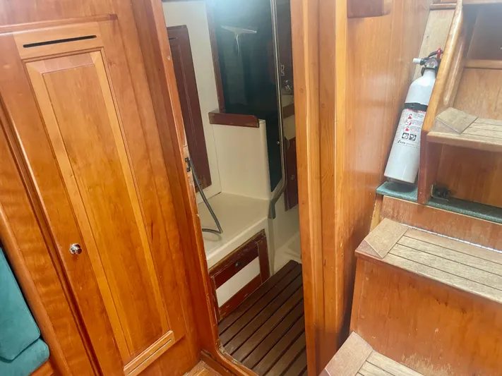  Yacht Photos Pics Interior of 2001 Tartan 4100 sailboat with wooden cabinetry and stairs.