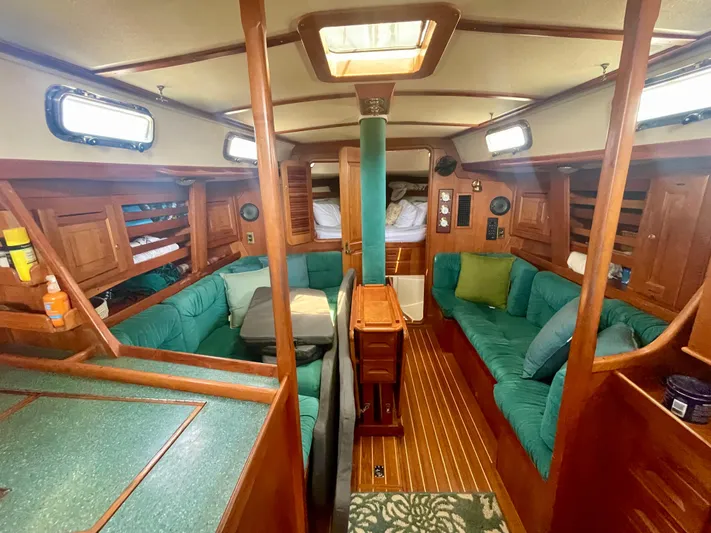  Yacht Photos Pics Interior of 2001 Tartan 4100 sailboat with green seating and wooden finishes.