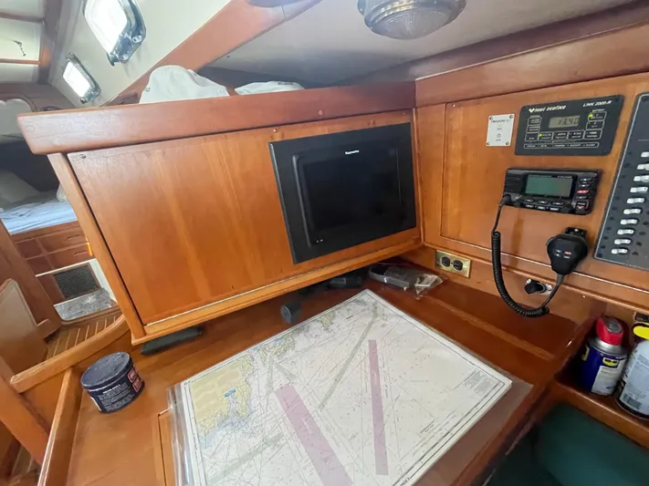  Yacht Photos Pics Navigation station on 2001 Tartan 4100 sailboat with chart, radio, and equipment.
