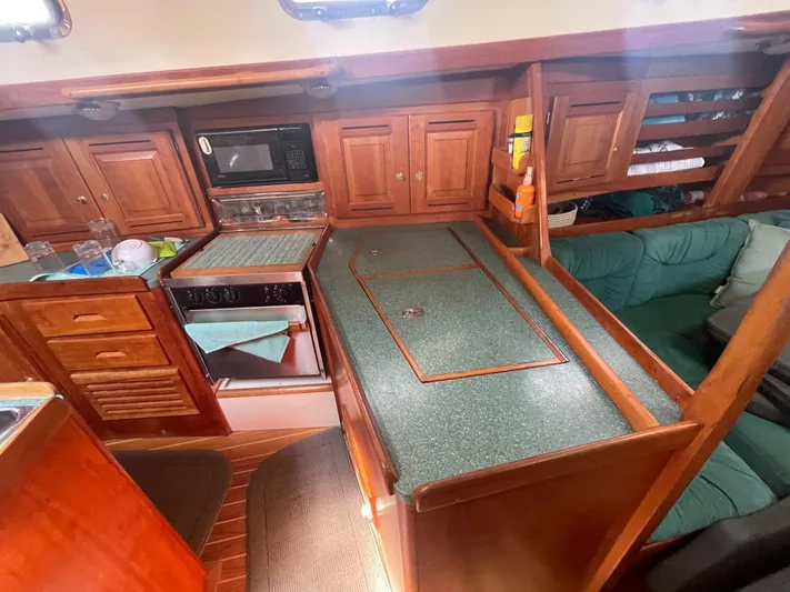  Yacht Photos Pics Tartan 4100 yacht interior kitchen with wooden cabinets and green countertops, 2001 model.