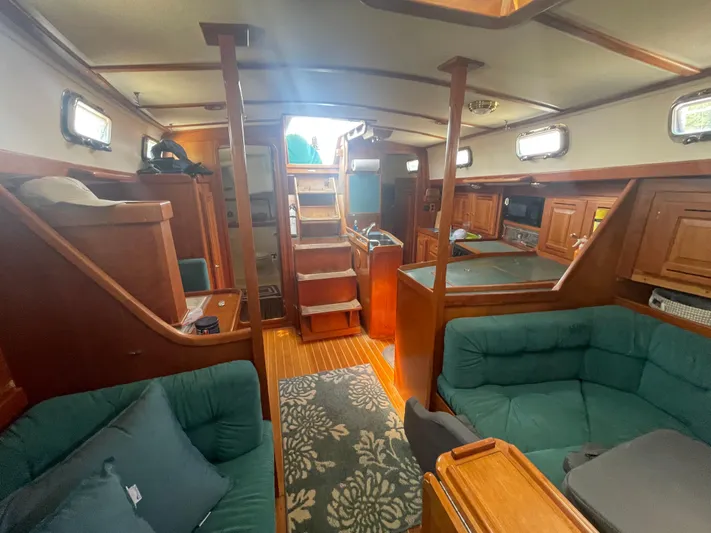  Yacht Photos Pics Interior of 2001 Tartan 4100 sailboat with wooden cabinetry and green seating.