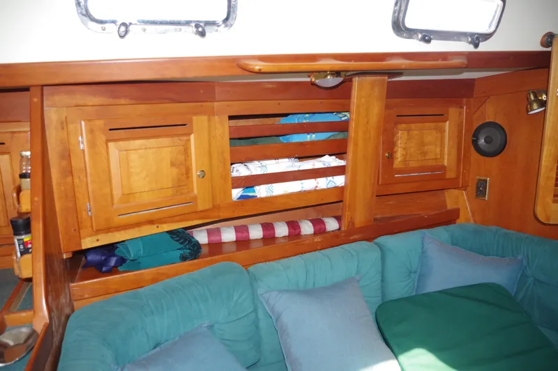 Yacht Photos Pics Interior of 2001 Tartan 4100 sailboat with wooden cabinets and teal cushions.