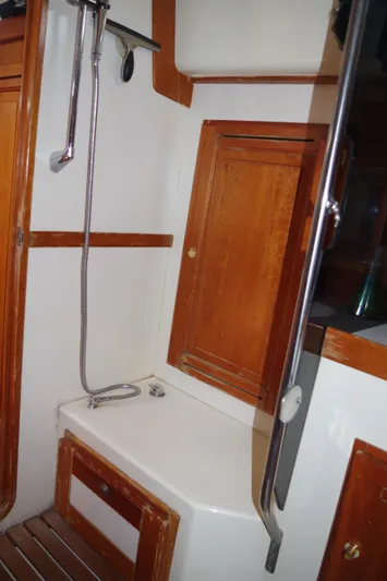  Yacht Photos Pics 2001 Tartan 4100 yacht bathroom with wooden cabinets and shower.