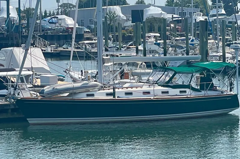  Yacht Photos Pics Sailboat docked in marina, Tartan 4100 model, 2001, with green canopy.