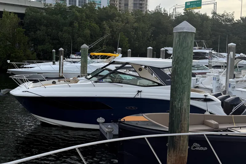  Yacht Photos Pics 2021 Sea Ray Sundancer 320 Coupe OB docked in a marina, surrounded by other boats.