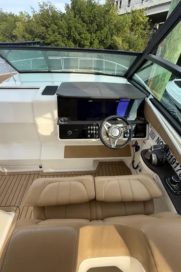  Yacht Photos Pics 2021 Sea Ray Sundancer 320 Coupe OB helm with modern controls and tan seating.