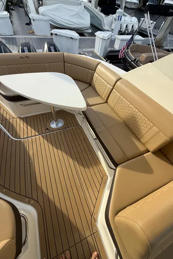  Yacht Photos Pics 2021 Sea Ray Sundancer 320 Coupe OB, luxurious tan seating with a sleek white table.