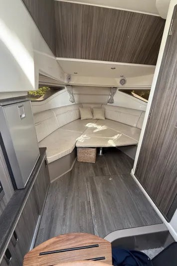  Yacht Photos Pics Interior of 2021 Sea Ray Sundancer 320 Coupe OB, featuring modern seating and wood accents.