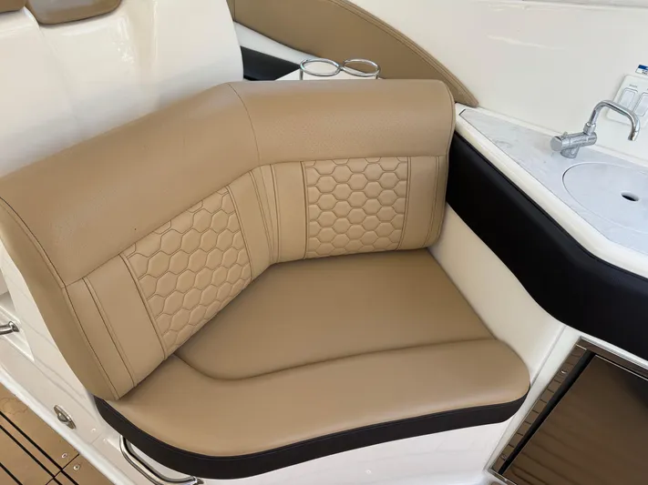  Yacht Photos Pics Luxurious tan seating on 2021 Sea Ray Sundancer 320 Coupe Outboard boat interior.