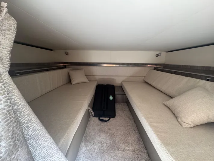  Yacht Photos Pics 2021 Sea Ray Sundancer 320 Coupe Outboard cabin interior with beige seating and cushions.
