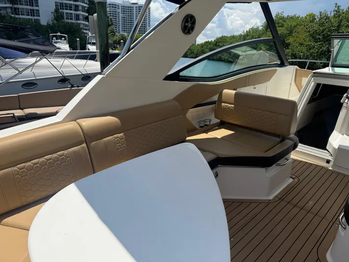  Yacht Photos Pics 2021 Sea Ray Sundancer 320 Coupe Outboard interior with tan seating and sleek design.