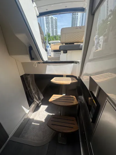  Yacht Photos Pics Interior view of 2021 Sea Ray Sundancer 320 Coupe Outboard with wooden steps and seating.