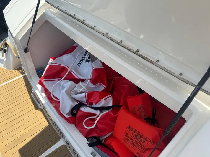 Yacht Photos Pics Storage compartment on 2021 Sea Ray Sundancer 320 Coupe Outboard with life jackets and gear.