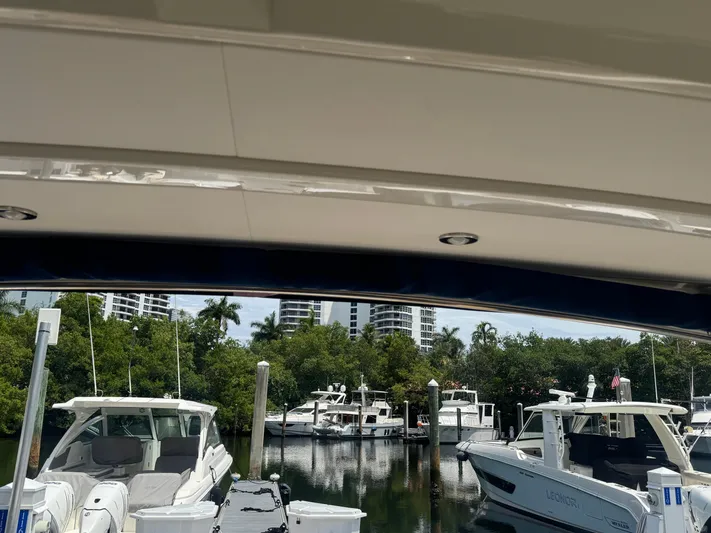  Yacht Photos Pics 2021 Sea Ray Sundancer 320 Coupe Outboard docked in a marina with other boats.