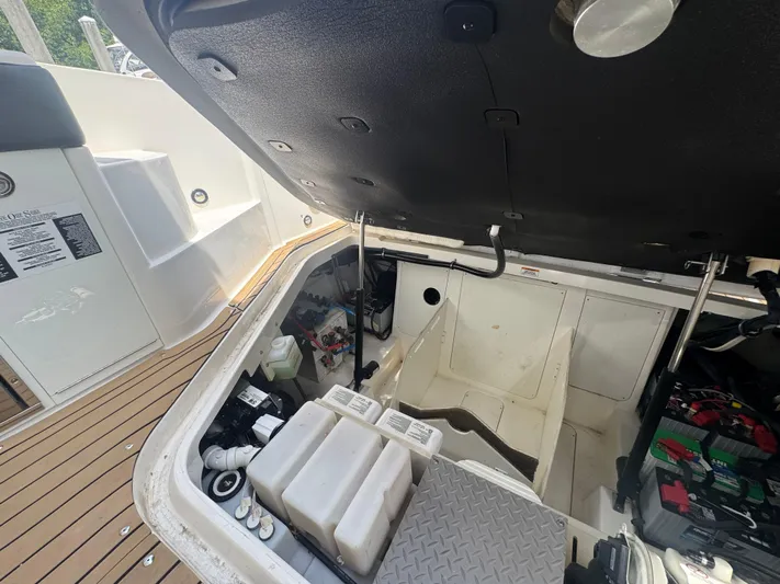  Yacht Photos Pics Open engine compartment of 2021 Sea Ray Sundancer 320 Coupe Outboard, showcasing internal components.