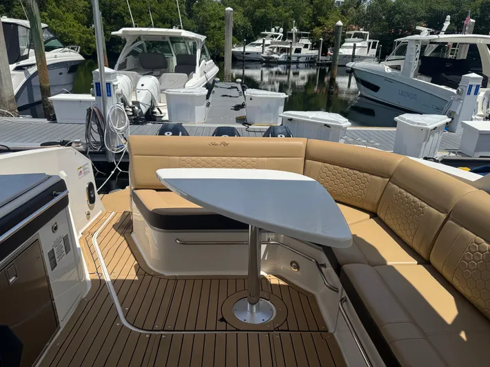 Yacht Photos Pics 2021 Sea Ray Sundancer 320 Coupe Outboard with elegant seating and table, docked at marina.