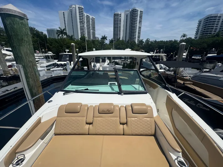  Yacht Photos Pics 2021 Sea Ray Sundancer 320 Coupe Outboard docked, with city skyline in background.