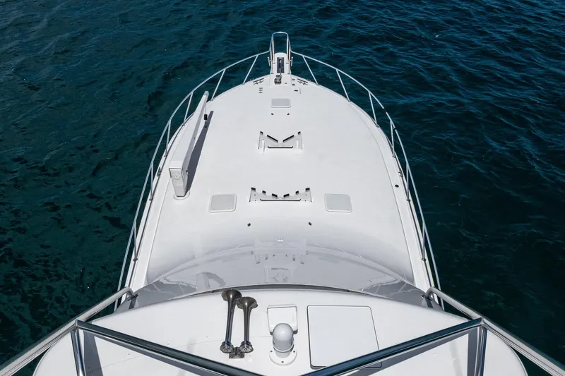 Adrian & Leidiana Yacht Photos Pics Bow view of 2005 Viking 61 yacht on open water.