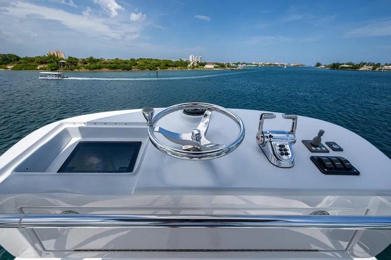 Adrian & Leidiana Yacht Photos Pics Helm of 2005 Viking 61 yacht with ocean view and modern controls.