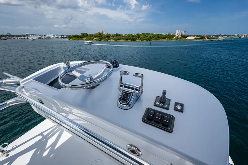 Adrian & Leidiana Yacht Photos Pics Control panel of a 2005 Viking 61 yacht overlooking scenic coastal waters.