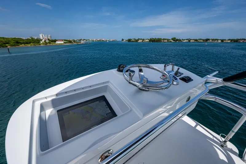 Adrian & Leidiana Yacht Photos Pics Helm of 2005 Viking 61 yacht with ocean view and navigation display.