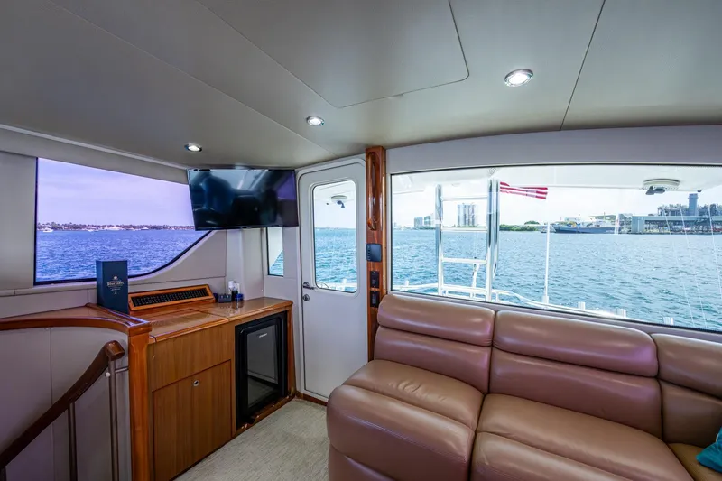 Adrian & Leidiana Yacht Photos Pics Luxurious interior of 2005 Viking 61 yacht with leather seating and ocean view.