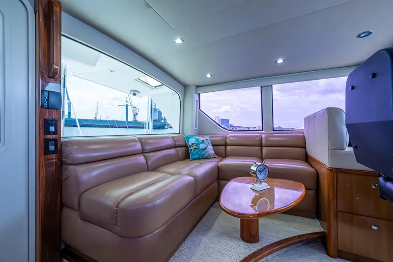 Adrian & Leidiana Yacht Photos Pics Luxurious interior of 2005 Viking 61 yacht with leather seating and ocean view.