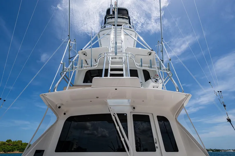 Adrian & Leidiana Yacht Photos Pics 2005 Viking 61 yacht, viewed from below, against a clear blue sky.