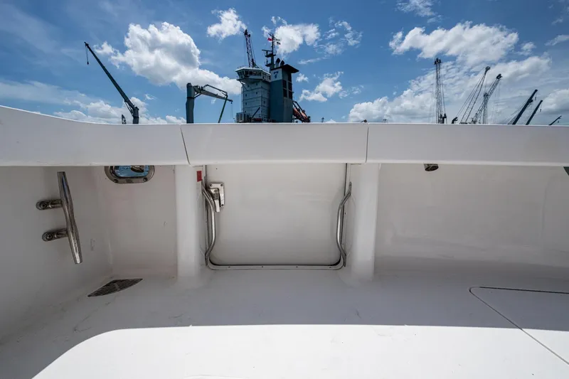 Adrian & Leidiana Yacht Photos Pics 2005 Viking 61 yacht deck with clear sky and cranes in background.