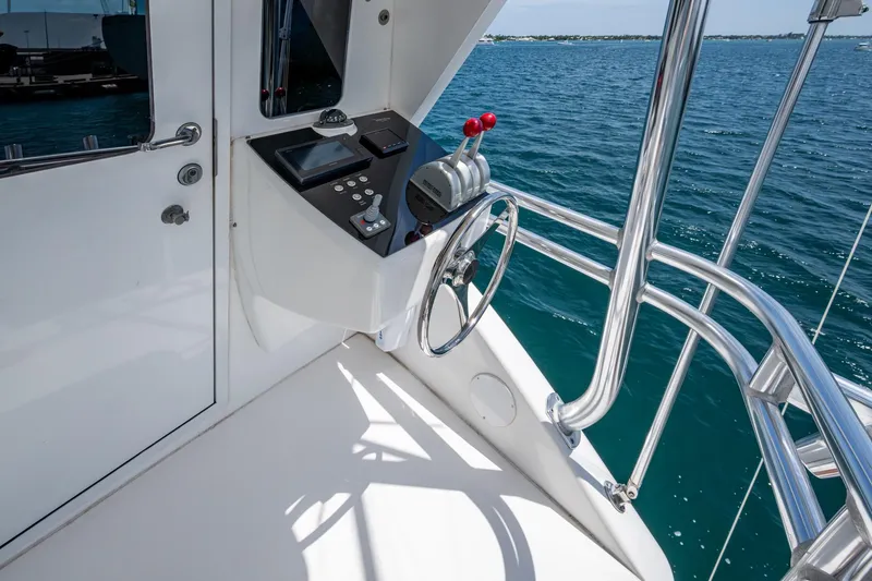 Adrian & Leidiana Yacht Photos Pics Control station of a 2005 Viking 61 yacht overlooking the ocean.