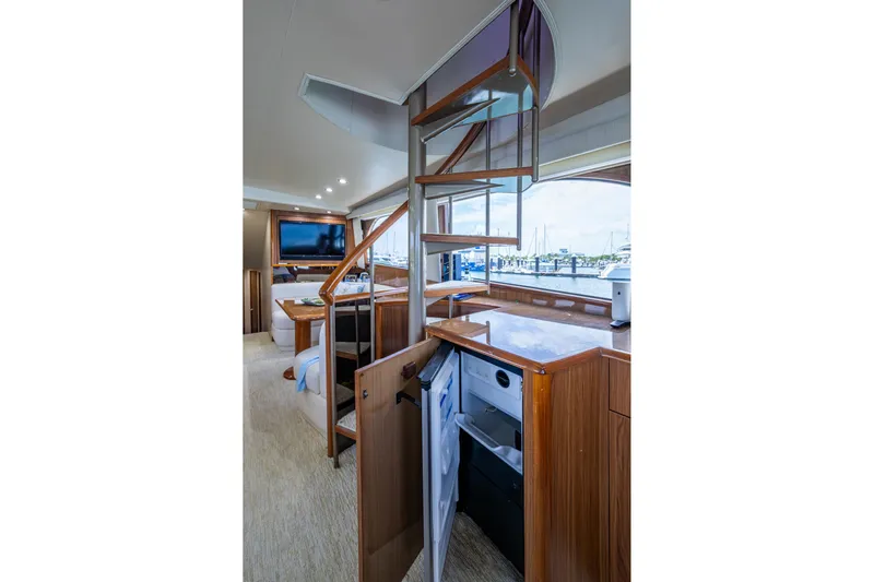 Adrian & Leidiana Yacht Photos Pics Luxurious interior of 2005 Viking 61 yacht with modern staircase and elegant wood finishes.