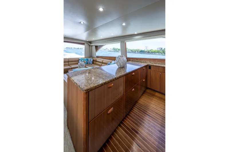 Adrian & Leidiana Yacht Photos Pics Luxurious interior of 2005 Viking 61 yacht with elegant wood cabinetry and granite countertops.