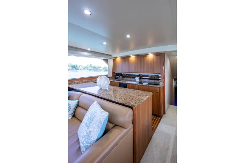 Adrian & Leidiana Yacht Photos Pics Luxurious interior of 2005 Viking 61 yacht with elegant wood and granite finishes.