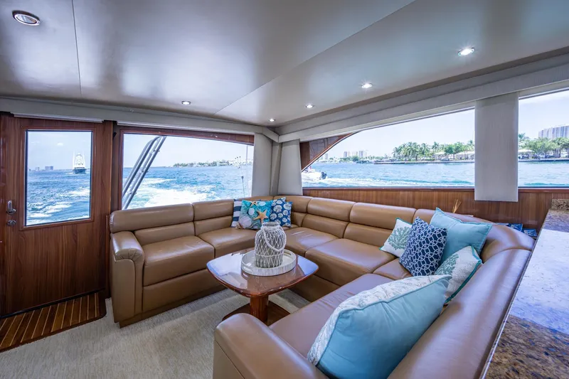 Adrian & Leidiana Yacht Photos Pics Luxurious interior of 2005 Viking 61 yacht with leather seating and ocean view.