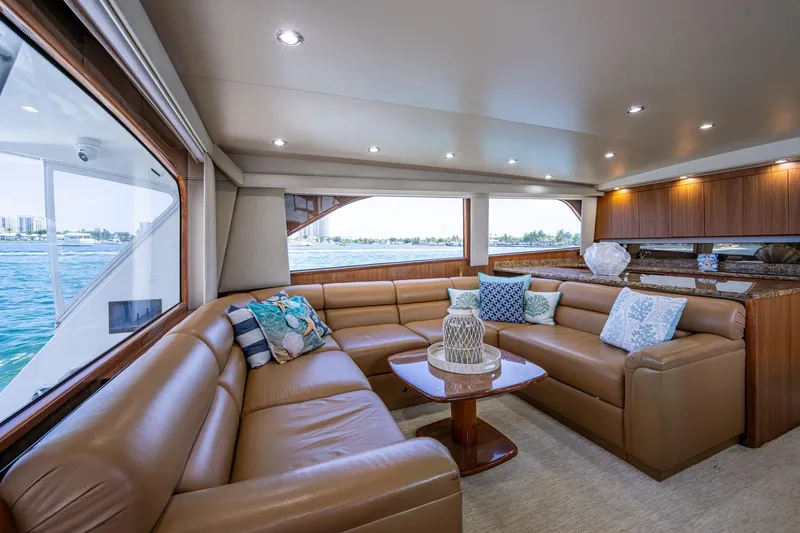 Adrian & Leidiana Yacht Photos Pics Luxurious interior of 2005 Viking 61 yacht with leather seating and ocean view.