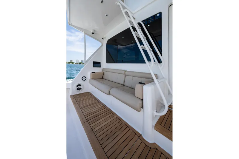 Adrian & Leidiana Yacht Photos Pics Luxurious 2005 Viking 61 yacht interior with beige seating and wooden flooring.