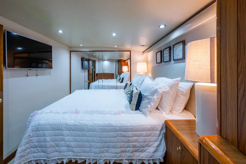 Adrian & Leidiana Yacht Photos Pics Luxurious bedroom interior on 2005 Viking 61 yacht with cozy bedding and modern decor.