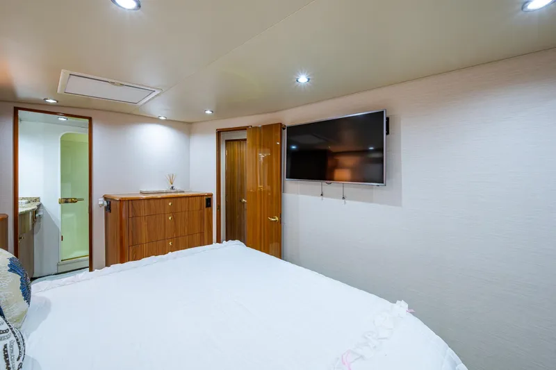 Adrian & Leidiana Yacht Photos Pics Luxurious cabin interior of 2005 Viking 61 yacht with TV and wooden furnishings.