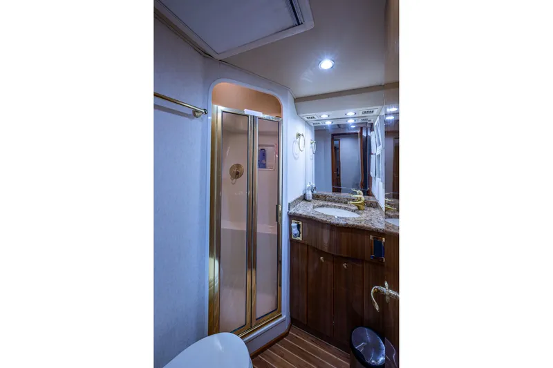 Adrian & Leidiana Yacht Photos Pics Luxurious bathroom in 2005 Viking 61 yacht with granite countertop and enclosed shower.