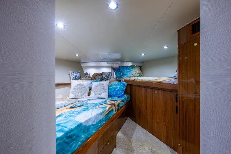 Adrian & Leidiana Yacht Photos Pics Luxurious cabin interior of 2005 Viking 61 yacht with ocean-themed bedding.