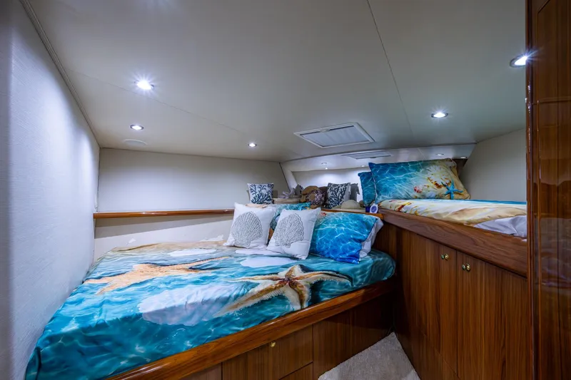 Adrian & Leidiana Yacht Photos Pics Luxurious 2005 Viking 61 yacht cabin with starfish-themed bedding and elegant wood finishes.
