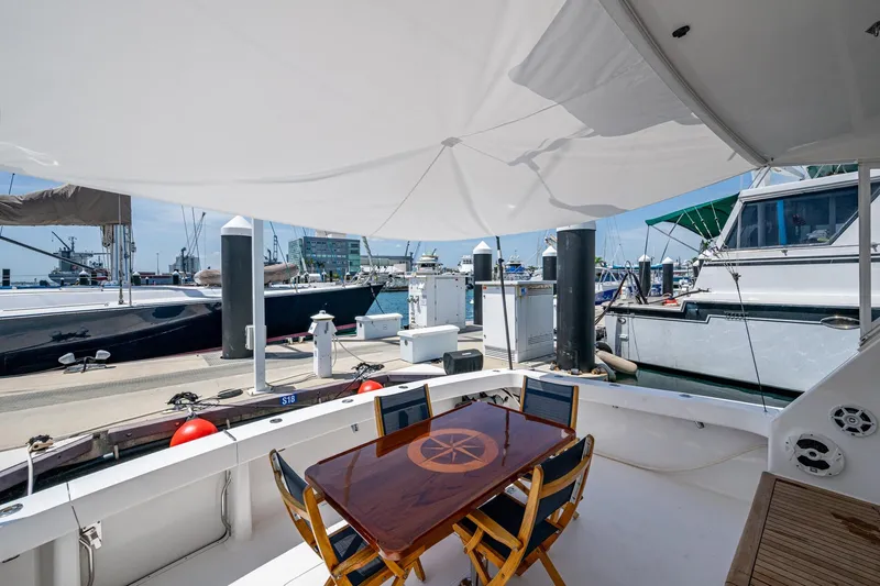 Adrian & Leidiana Yacht Photos Pics 2005 Viking 61 yacht deck with shaded seating area at marina.