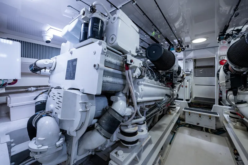 Adrian & Leidiana Yacht Photos Pics Engine room of a 2005 Viking 61 yacht, showcasing powerful machinery and clean design.