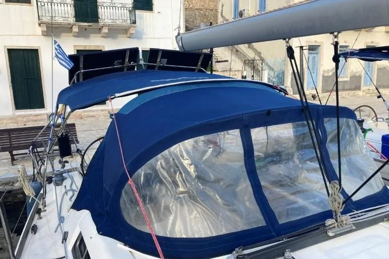 Panopaea Yacht Photos Pics 2011 Dufour 405 GL sailboat with blue canopy docked in a marina.