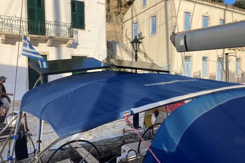 Panopaea Yacht Photos Pics Sailboat Dufour 405 GL (2011) docked, featuring blue canopy and Greek flag.